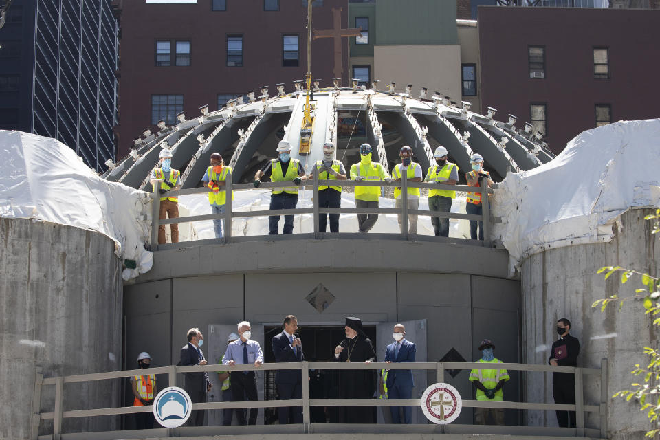 A group of clergy, politicians and construction workers attends a ceremony at the St. Nicholas Greek Orthodox Church, Monday, Aug. 3, 2020 at the World Trade Center in New York. The original church was destroyed in the attacks of Sept. 11, 2001. The shrine is expected to open in 2021. (AP Photo/Mark Lennihan)