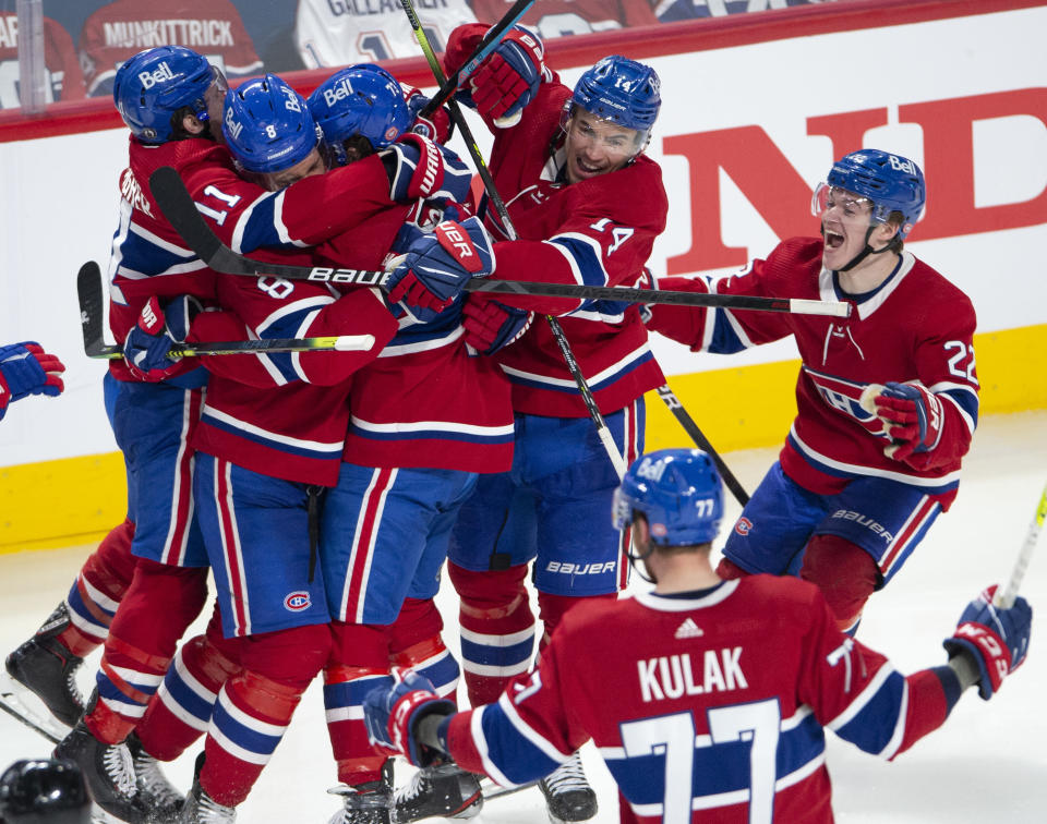 Montreal Canadiens right wing Tyler Toffoli (73) is mobbed by teammates after scoring the winning goal following overtime NHL Stanley Cup playoff hockey action against the Winnipeg Jets in Montreal, Monday, June 7, 2021. (Ryan Remiorz/The Canadian Press via AP)