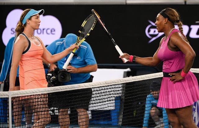 Serena Williams, right, touches rackets with Danielle Collins