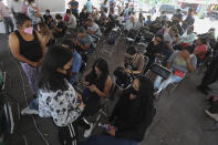 People wait for the remains of relatives that died during the collapse of an elevated section of the city's subway system, outside a morgue in Mexico City, Tuesday, May 4, 2021. The elevated section of the metro collapsed late Monday, killing at least 23 people and injuring at least 79, city officials said. (AP Photo/Marco Ugarte)