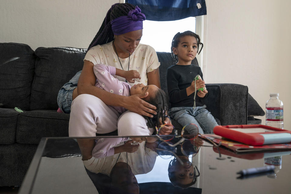 Christina Engram spends time at home with daughter, Neveah, 6, and son, Choncey (R), 4, in Oakland, Calif., on Friday Nov. 24, 2023. “She knows her numbers. She knows her ABC’s. She knows how to spell her name,” Engram says. “But when she feels frustrated that she can’t do something, her frustration overtakes her. She needs extra attention and care. She has some shyness about her when she thinks she’s going to give the wrong answer.” (AP Photo/Loren Elliott)