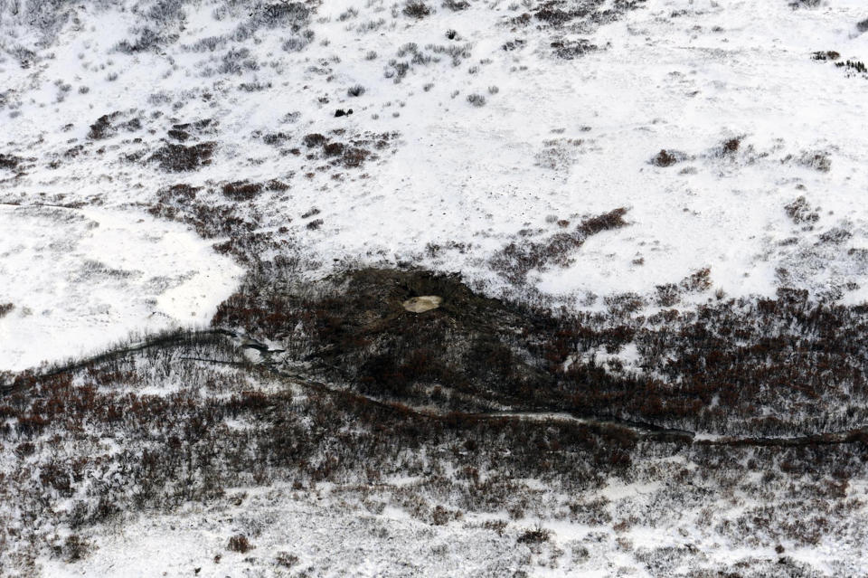 FILE - This Nov. 17, 2010 file photo provided by the U.S. Air Force shows an aerial view of the F-22 crash site located approximately 100 miles (161 kilometers) north of Anchorage, Alaska. Years before F-22 pilots began getting dizzy in the cockpit, before one struggled to breathe as he tried to pull out of a fatal crash, before two more went on television to say the plane was so unsafe they refused to fly it, a small circle of U.S. Air Force experts knew something was wrong with the prized stealth fighter jet. (AP Photo/U.S. Air Force,Master Sgt. Jeremiah Erickson, File)