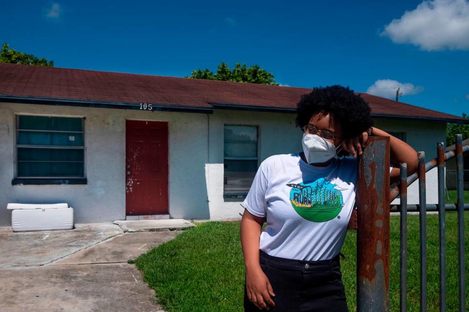 Kil’mari Phillips stands outside her home in South Bay, Florida — a few hundred feet away from Rosenwald Elementary School and the acres of sugarcane adjacent to it in Palm Beach County.