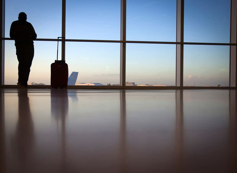 FILE PHOTO: A passenger looks out the window at Miami International Airport in Miami