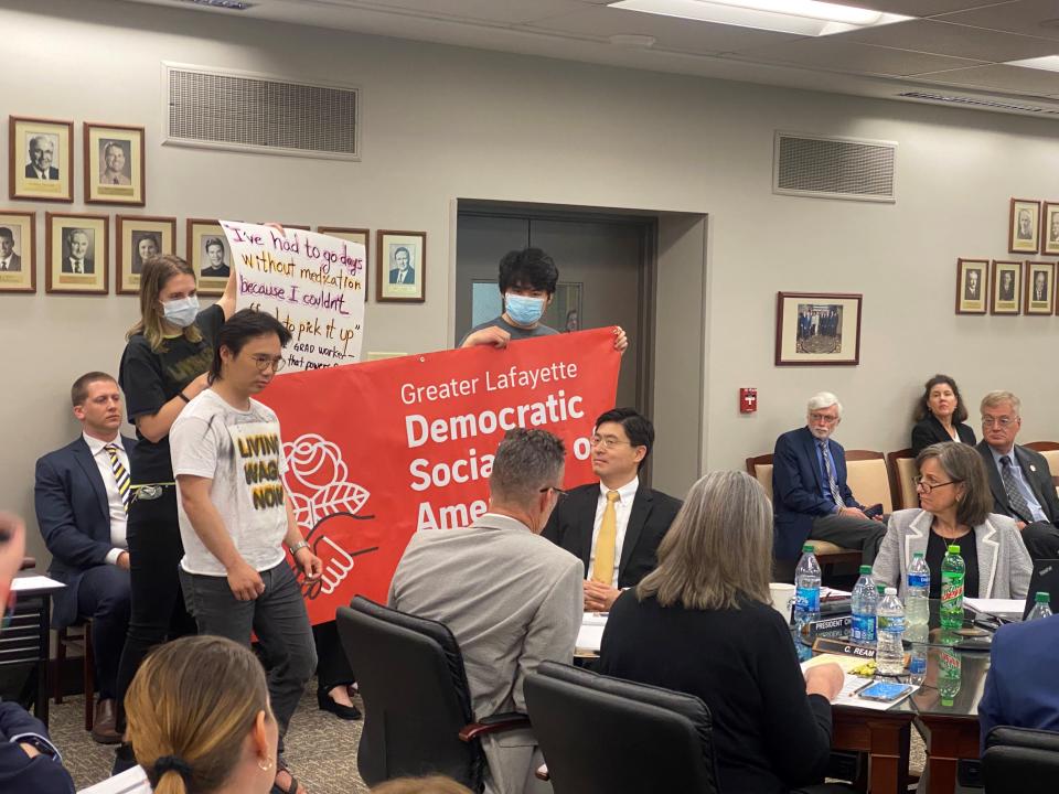 Members of the Greater Lafayette Democratic Socialists of America and of the Living Wage Campaign present a petition to the Purdue Board of Trustees for higher minimum yearly wages for graduate students.