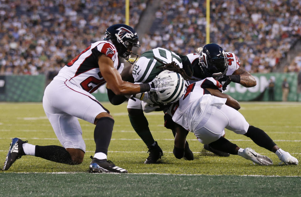 New York Jets running back Isaiah Crowell (20) breaks a tackle by Atlanta Falcons' Isaiah Oliver (20) to score a touchdown. No flags were thrown for an illegal hit on this play. (AP)