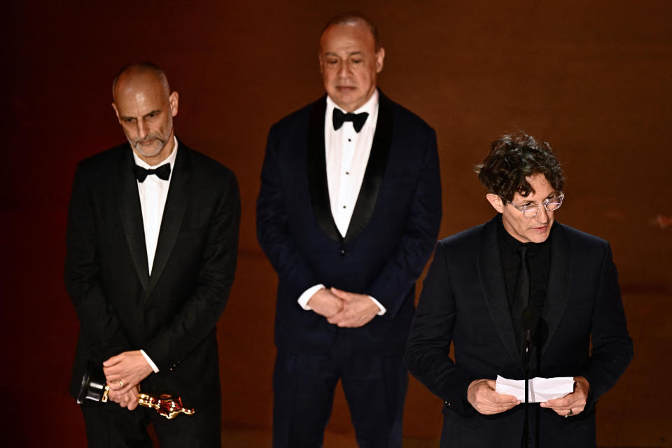 English director Jonathan Glazer (R) accepts the award for Best International Feature Film for 