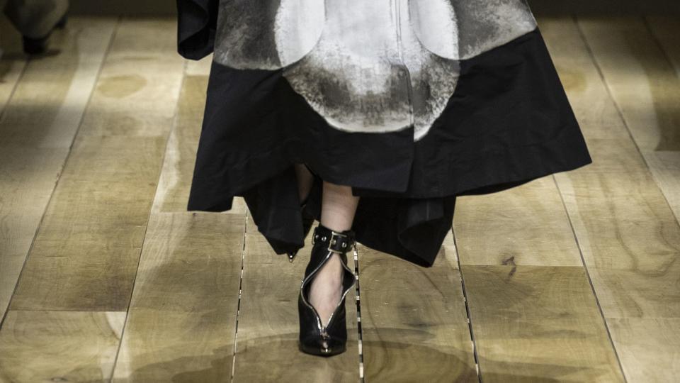 a black coat printed with a white botanical motif from mcqueen fall 2023