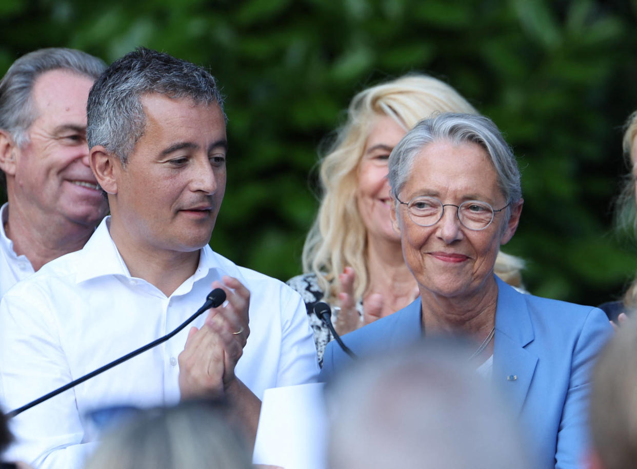French Interior Minister Gerald Darmanin (R) applauds French Prime Minister Elisabeth Borne as they sing La Marseillaise, the national anthem of France, during an "afternoon of discussion" on "the expectations of the working classes" at the Botanical Garden in Tourcoing, northern France, on August 27, 2023. (Photo by FRANCOIS LO PRESTI / AFP)
