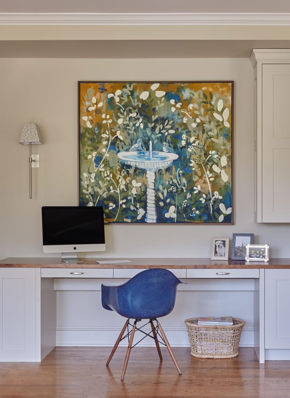 An Eames chair makes those computer searches much more comfortable to navigate, and the sconce is by Urban Electric.