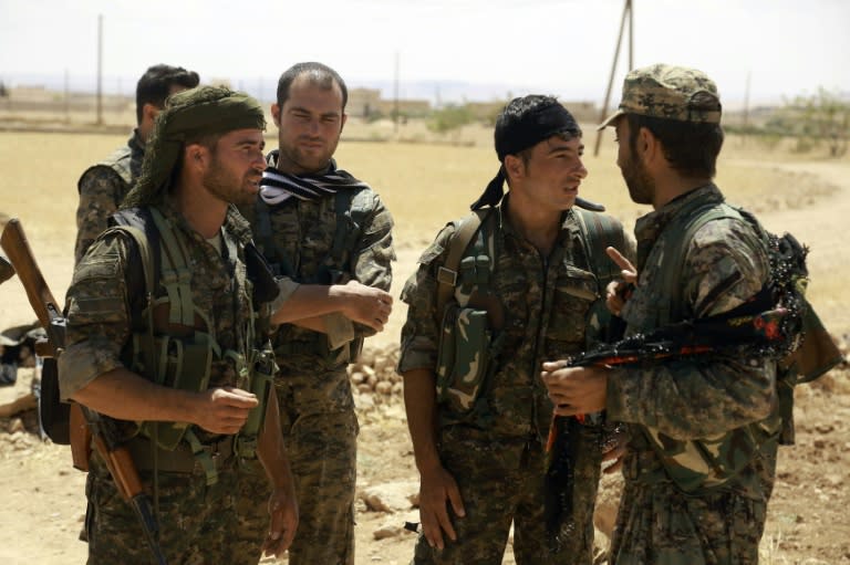 Fighters from the Syrian Democratic Forces (SDF) gather on the outskirts of the northern Syrian town of Manbij, on June 10, 2016