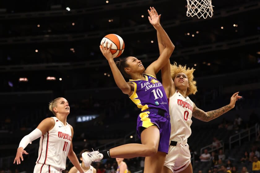 LOS ANGELES, CALIFORNIA - JULY 12: Olivia Nelson-Ododa #10 of the Los Angeles Sparks goes up for a shot against Shakira Austin #0 of the Washington Mystics in the first half at Crypto.com Arena on July 12, 2022 in Los Angeles, California. NOTE TO USER: User expressly acknowledges and agrees that, by downloading and or using this photograph, User is consenting to the terms and conditions of the Getty Images License Agreement. (Photo by Katharine Lotze/Getty Images)