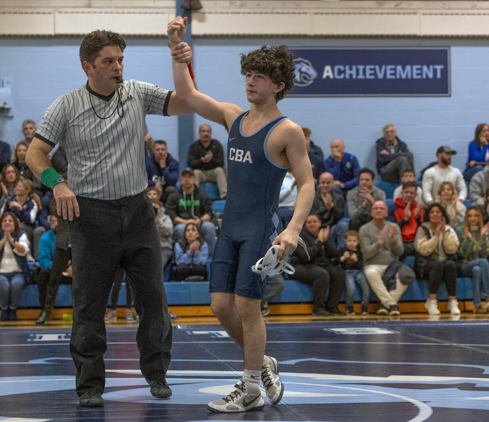 Christian Brothers Academy freshman 113-pounder Paul Kenny gets his hand raised by referee Mike Rossi after his pin of Middletown North's Brady Klinsky Thursday night.