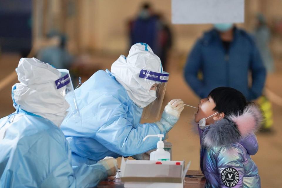 A medical worker collects a swab sample from a child at a COVID-19 testing site in Daxing District of Beijing, capital of China, Jan. 20, 2021.<span class="copyright">Xinhua/Ju Huanzong via Getty Images</span>