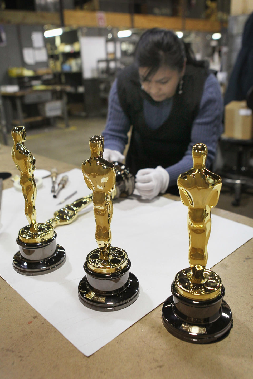 CHICAGO, IL - FEBRUARY 09: Josefina Govea assembles an Oscar statuette at R.S. Owens & Company February 9, 2012 in Chicago, Illinois. R.S. Owens manufactures the Oscar statuettes which are presented at the annual Academy Awards by the Academy of Motion Picture Arts and Sciences. After the theft of the statuettes prior to the 2000 Academy Awards the company began casting the statuettes one year in advance of the show. (Photo by Scott Olson/Getty Images)