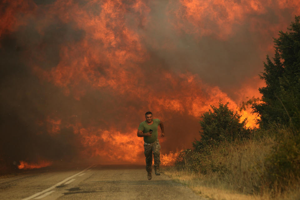 A firefighter runs as a wildfire intensifies in Evros, Greece, August 31, 2023. / Credit: Ayhan Mehmet/Anadolu Agency/Getty