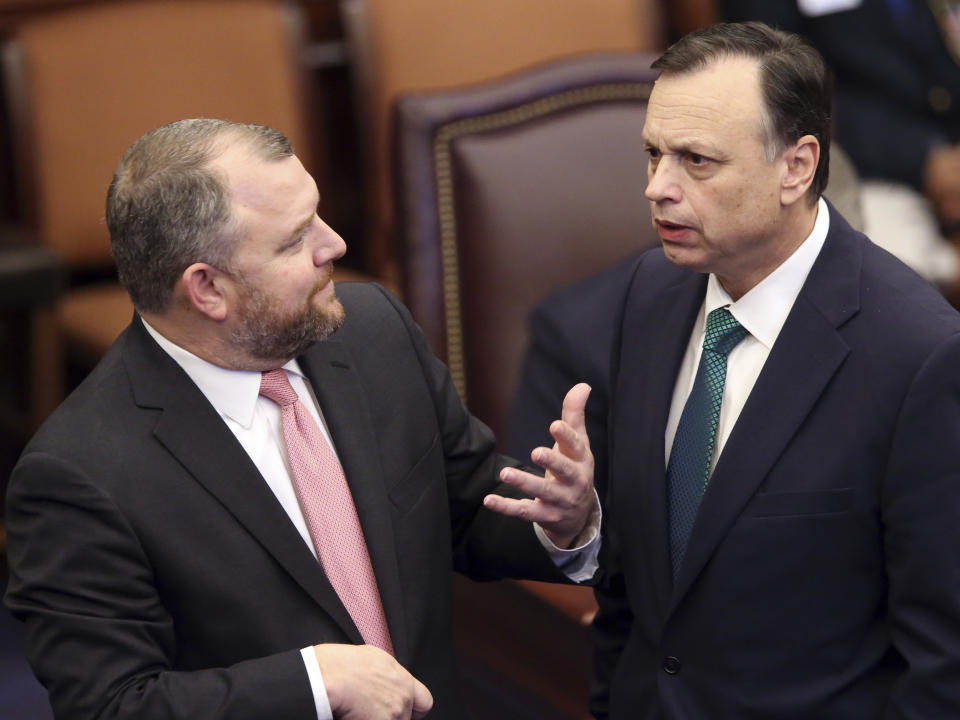 CORRECTS FIRST NAME TO ROB, INSTEAD OF ROY - Sen. Rob Bradley, R-Fleming Island, left, confers with Sen. Tom Lee, R-Brandon during the debate on a bill to allow teachers to be armed during session Wednesday April 17, 2019, in Tallahassee, Fla. (AP Photo/Steve Cannon)