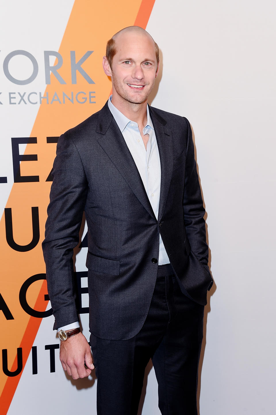 Alexander Skarsgård wearing his new ’do and a dark gray suit at the Louis Vuitton “Voyez, Voguez, Voyagez” event red carpet Thursday night in New York. (Photo: Getty Images)