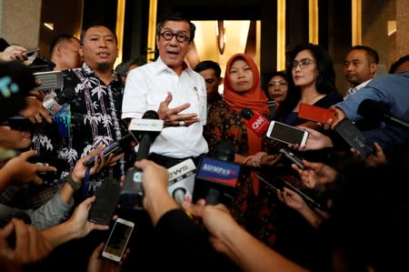 Indonesia's Law and Human Rights Minister Yasonna Laoly talks to journalists during a press conference with Baiq Nuril Maknun, a teacher on the island of Lombok who was jailed after she tried to report sexual harassment, in Jakarta