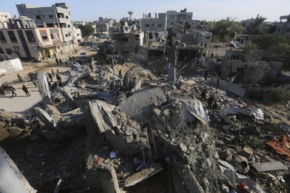 Palestinians look at the destruction by the Israeli bombardment of the Gaza Strip in Rafah, Monday, Dec. 4, 2023. (AP Photo/Hatem Ali)