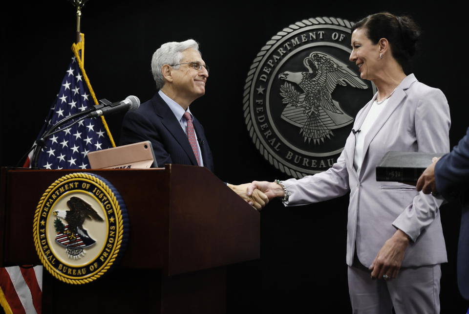 Attorney General Merrick Garland shakes hands with Colette Peters, director of the federal Bureau of Prisons, after she was sworn in at BOP headquarters in Washington, Tuesday, Aug. 2, 2022. (Evelyn Hockstein/Pool Photo via AP)