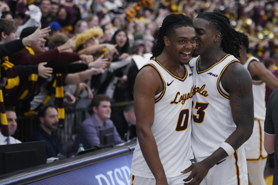 Loyola Chicago's Des Watson (0) and Philip Alston (23) celebrate the team's 77-72 win over Dayton in an NCAA college basketball game Friday, March 1, 2024, in Chicago. (AP Photo/Paul Beaty)