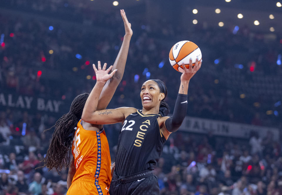 Las Vegas Aces forward A'ja Wilson (22) gets inside of Connecticut Sun forward Jonquel Jones (35) to shoot during the first half in Game 1 of a WNBA basketball final playoff series Sunday, Sept. 11, 2022, in Las Vegas. (AP Photo/L.E. Baskow)