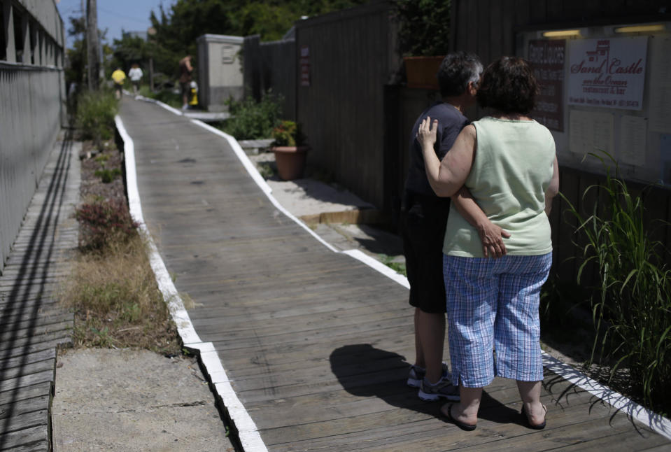 In this June 23, 2013 photo, two woman peruse a menu in the Fire Island community of Cherry Grove, N.Y. Locals note that 20 years before the Stonewall riots in New York City helped launch the gay rights movement, gays and lesbians were freely expressing themselves in Cherry Grove. The seaside resort, about 60 miles east of Manhattan, was known as far back as the late 1940s as a sanctuary where gay writers, actors and business people from the city and beyond escaped to relax, hold hands and show affection in public. (AP Photo/Seth Wenig)