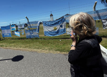 A woman looks at banners in support of the 44 crew members of the missing at sea ARA San Juan submarine, outside an Argentine naval base in Mar del Plata, Argentina November 25, 2017. REUTERS/Marcos Brindicci