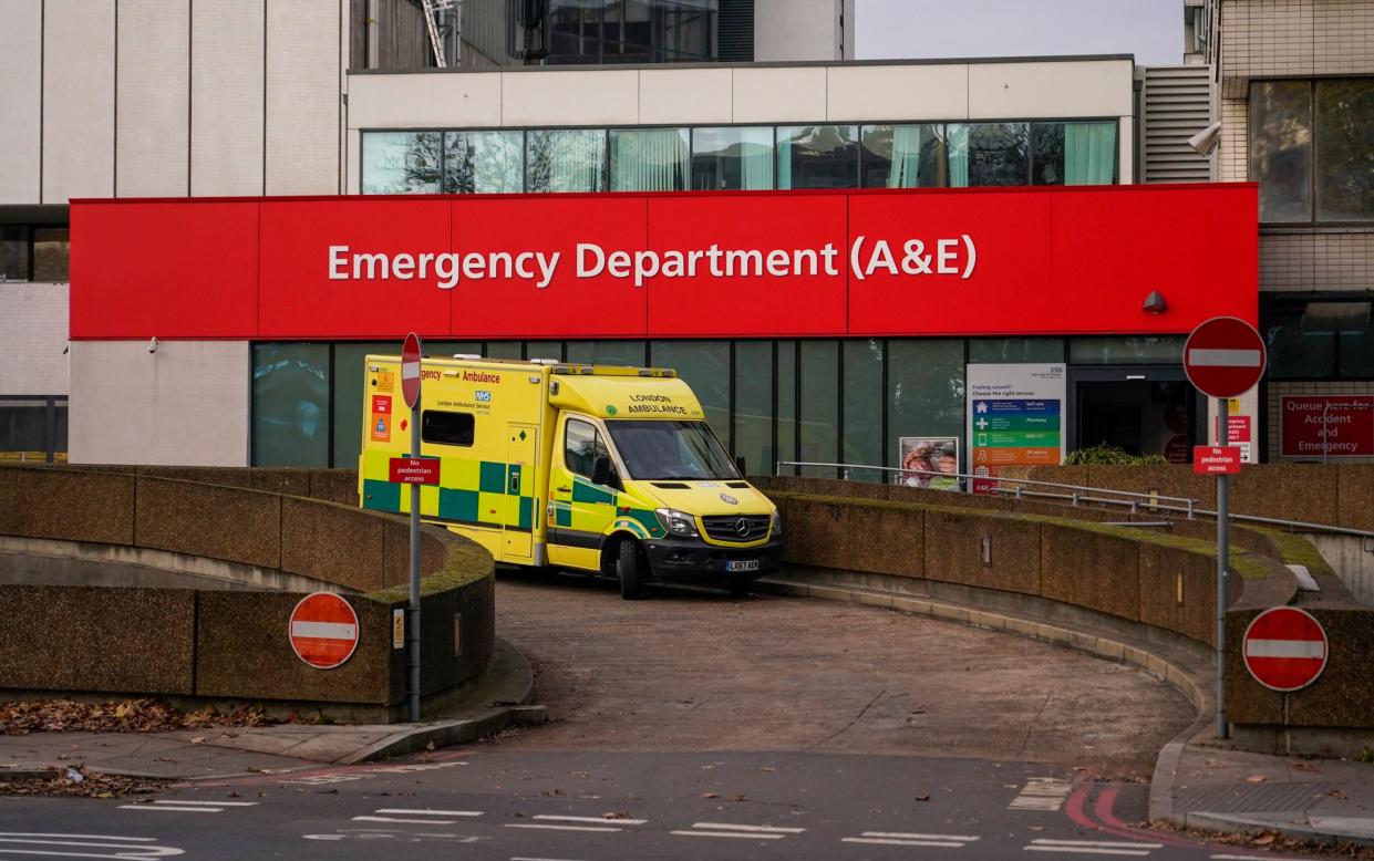 An ambulance is parked outside St Thomas' Hospital, in London - Alberto Pezzali/AP