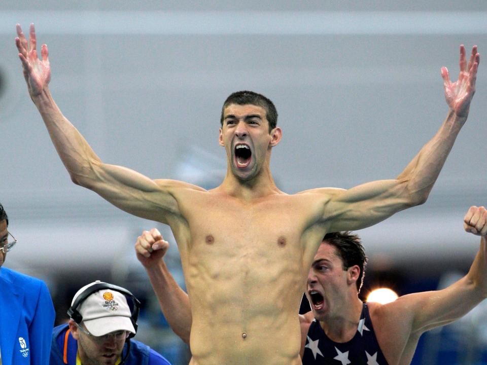 Michael Phelps reacts after winning gold