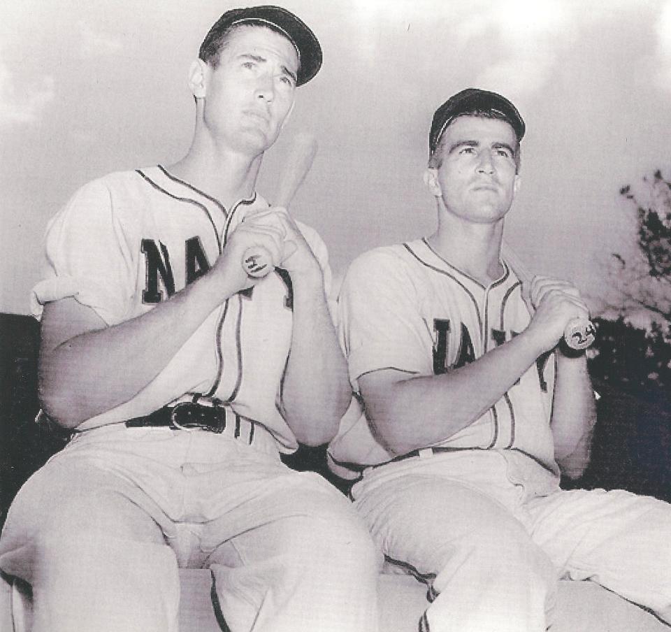 Ted Williams, left, sits with a teammate.