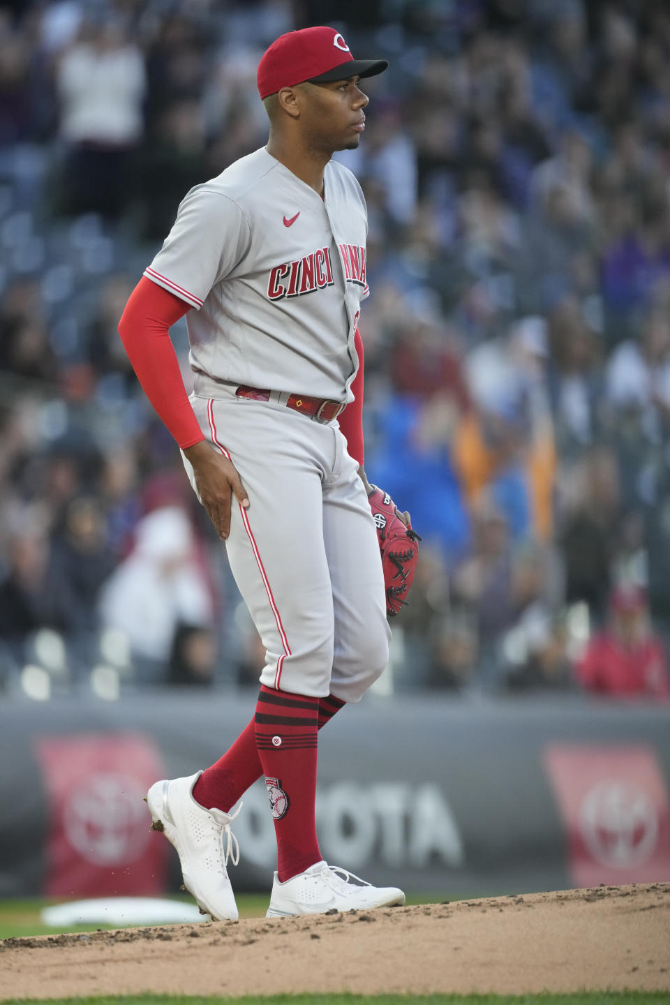 Cincinnati Reds starting pitcher Hunter Greene reacts after giving up a solo home run to Colorado Rockies' Elias Diaz during the second inning of a baseball game Friday, April 29, 2022, in Denver. (AP Photo/David Zalubowski)