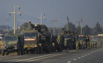 FILE - In this Feb. 14, 2020, file photo, Turkish troops and artillery prepare to enter Syria, in Reyhanli, Hatay, Turkey. Syria’s civil war has long provided a free-for-all battlefield for proxy fighters. But in its ninth year, the war is drawing major foreign actors into direct conflict, with the threat of all-out confrontations becoming a real possibility. (AP Photo, File)