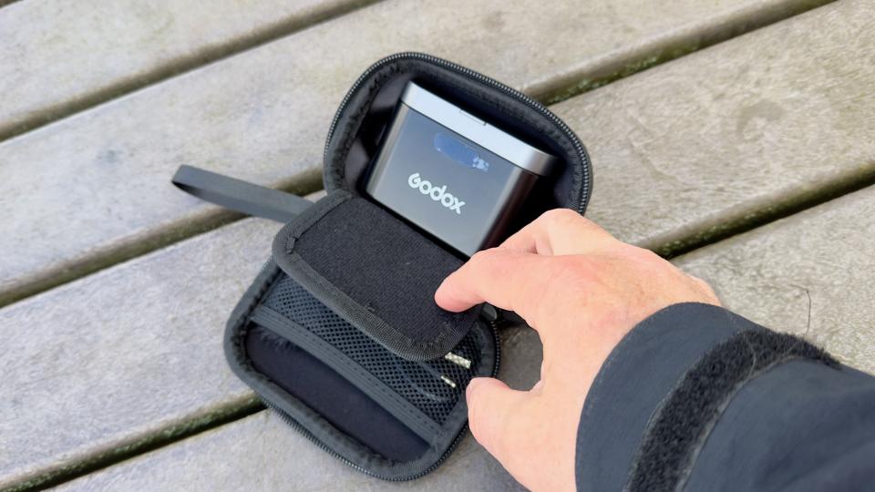 Hand removing Godox WES2 Microphone from a case