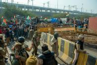 NEW DELHI, INDIA - 2021/01/26: Farmers break police barricades in the presence of Delhi police during the farmers' tractor parade. Farmers protesting against agricultural reforms breached barricades and clashed with police in the capital on India's 72nd Republic Day. The police fired tear gas to restrain them, shortly after a convoy of tractors trundled through the Delhi's outskirts. (Photo by Pradeep Gaur/SOPA Images/LightRocket via Getty Images)