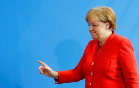 German Chancellor Angela Merkel gestures as she leaves after a joint news conference with Italian Prime Minister Giuseppe Conte (not pictured) at the chancellery in Berlin, Germany, June 18, 2018. REUTERS/Hannibal Hanschke