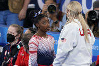 Simone Biles, of the United States, speaks with her coach Cecile Landi after performing on the balance beam during the artistic gymnastics women's apparatus final at the 2020 Summer Olympics, Tuesday, Aug. 3, 2021, in Tokyo, Japan. (AP Photo/Jae C. Hong)