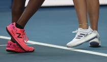 United States' Coco Gauff, left, and compatriot Caty McNally wear a tribute to Kobe Bryant on their shoes during their doubles match against Japan's Shuko Aoyama amd Ena Shibahara at the Australian Open tennis championship in Melbourne, Australia, Monday, Jan. 27, 2020. (AP Photo/Dita Alangkara)