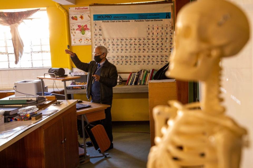 Biology teacher teaches in a classroom.