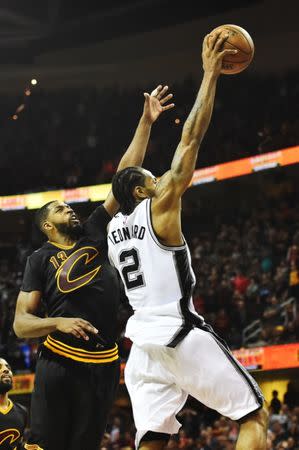 Jan 21, 2017; Cleveland, OH, USA; San Antonio Spurs forward Kawhi Leonard (2) slam dunks past Cleveland Cavaliers center Tristan Thompson (13) during overtime at Quicken Loans Arena. Mandatory Credit: Ken Blaze-USA TODAY Sports