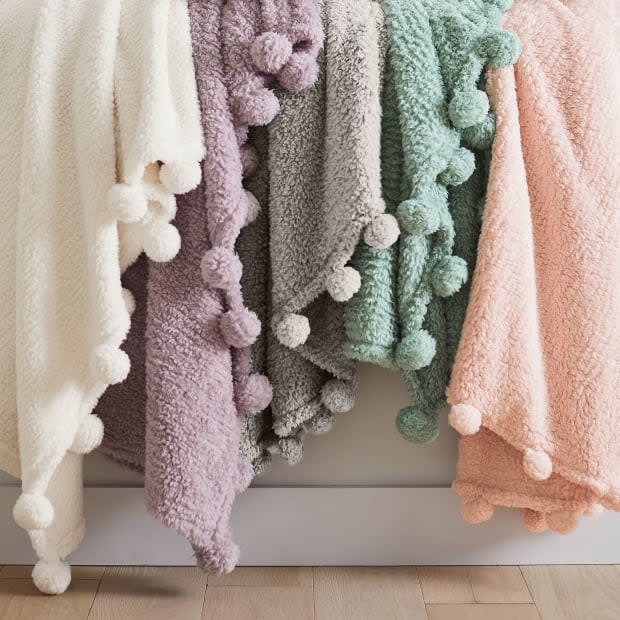 <p>This warm and toasty blanket is outlined with 26 pom-poms. It's available in several vibrant colors. Your teen will love it!</p><p><em><a href="https://go.skimresources.com?id=113896X1572730&xs=1&url=https%3A%2F%2Fwww.pbteen.com%2Fproducts%2Frecycled-cozy-pom-throw%2F%3Fpkey%3Ds%7eeaster%7e74&sref=parade.com%2Fshopping%2Feaster-gifts-teens" rel="noopener" target="_blank" data-ylk="slk:Cozy Pom Sherpa Throw, $49.50 at Pottery Barn Teen;elm:context_link;itc:0;sec:content-canvas" class="link ">Cozy Pom Sherpa Throw, $49.50 at Pottery Barn Teen</a></em></p><p>Pottery Barn Teen</p>