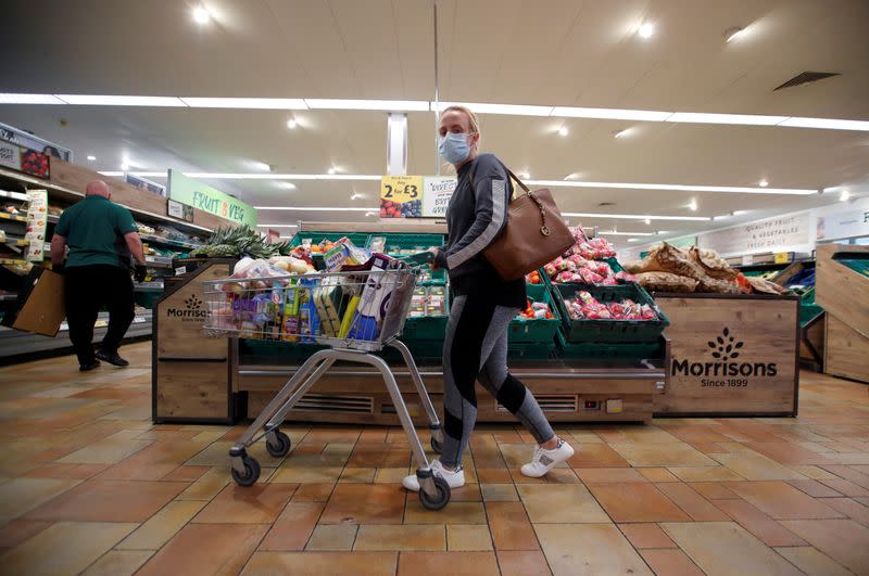 FILE PHOTO: A customer wearing a protective face mask shops at a Morrisons store in St Albans