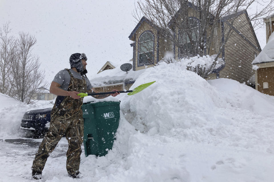 Ronnie Enriquez shovels snow from his driveway Wednesday, March 1, 2023, in Bellemont, Ariz. In Arizona, snow began falling Wednesday morning as the storm moved eastward and was poised to dump as much as 2 feet (60 centimeters) of snow in northern Arizona by Thursday morning. (AP Photo/Felicia Fonseca)