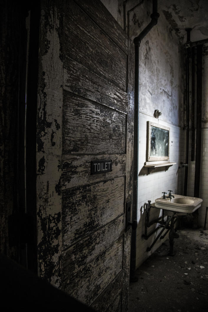 <p>The doorway of a restroom in a ward on Ellis Island. (Photo: Gordon Donovan/Yahoo News) </p>