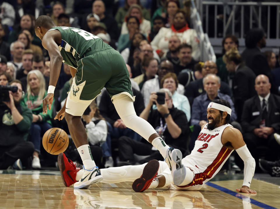 Milwaukee Bucks forward Khris Middleton (22) dribbles past Miami Heats' Gabe Vincent (2) during the first half of Game 5 in a first-round of an NBA basketball playoff series Wednesday, April 26, 2023, in Milwaukee. (AP Photo/Jeffrey Phelps)