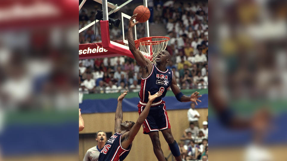 Mandatory Credit: Photo by Susan Ragan/AP/Shutterstock (7286460a)USA's Michael Jordan sails high above teammate Magic Johnson knocking away a shot during the first half of their preliminary round basketball game with Croatia at the Summer Olympics in Barcelona.