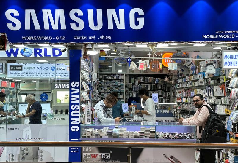 People shop inside a store selling Samsung mobile phones and accessories in Mumbai