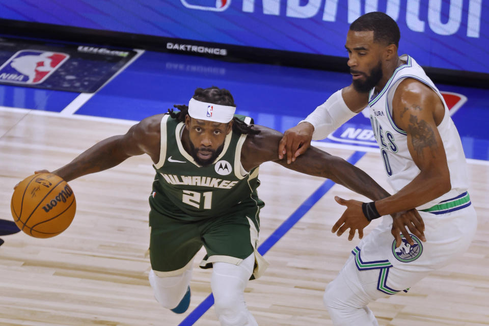 Milwaukee Bucks guard Patrick Beverley (21) works around Minnesota Timberwolves guard Mike Conley (10) during the second half of an NBA basketball game Friday, Feb. 23, 2024, in Minneapolis. (AP Photo/Bruce Kluckhohn)