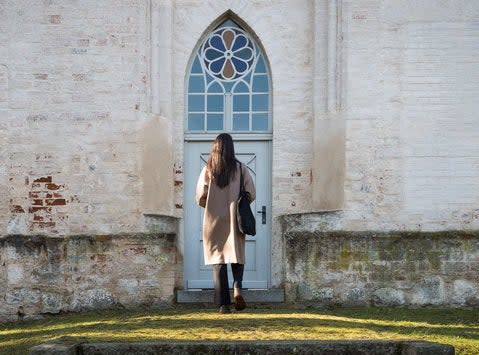 woman walking into a church